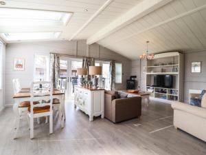 a kitchen and dining room with a table and a couch at Skylarks in Hengrave