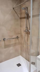 a shower in a bathroom with a glass door at Opening Doors Vilassar. Family house Beach & Relax in Vilassar de Mar
