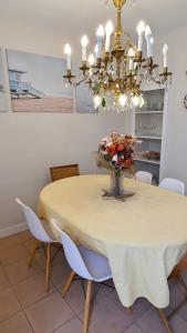 uma sala de jantar com uma mesa e um lustre em Opening Doors Vilassar. Family house Beach & Relax em Vilassar de Mar