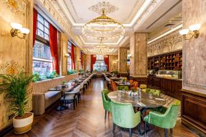 a restaurant with tables and chairs and a chandelier at Cronton Design Hotel in Istanbul