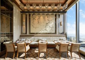 a dining room with a table and chairs and a large window at Four Seasons Hotel Tokyo at Otemachi in Tokyo