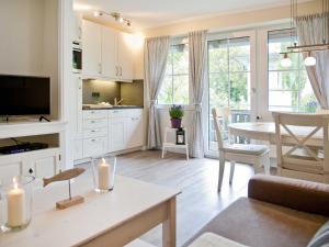 a living room with a kitchen and a dining room at TRA7c Ferienwohnung Kossmann in Niendorf