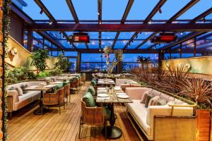 a restaurant with tables and chairs and a glass ceiling at Cronton Design Hotel in Istanbul