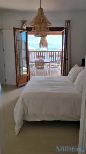 a bedroom with a bed with a view of the ocean at VILLA TEGALA by Villitas in Playa Blanca
