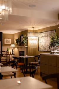 a dining room with tables and chairs and a fireplace at The Yard in Bath Hotel in Bath