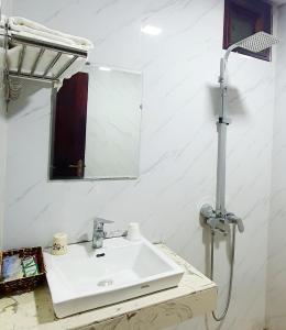 a bathroom with a white sink and a mirror at TRUC LAM HOTEL in Lao Cai +28 photos