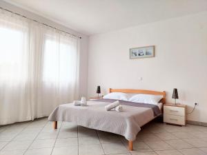 a bedroom with a bed with two towels on it at Apartments Dia in Zaostrog