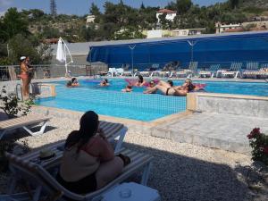 a group of people swimming in a swimming pool at Rose Hotel B&B in Patara