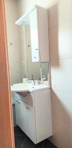 a bathroom with a sink and a mirror at Apartments Dia in Zaostrog