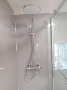 a shower with a shower head in a bathroom at Acer Holiday Cottage Tideswell village Buxton Peak District by Rework Accommodation in Tideswell +38 photos