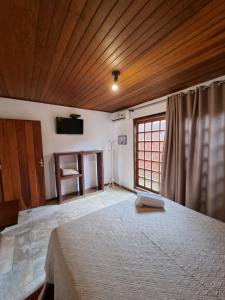 Cama ou camas em um quarto em Pousada Ikabana