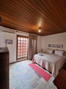 Cama ou camas em um quarto em Pousada Ikabana
