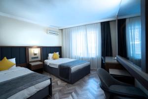 Ένα ή περισσότερα κρεβάτια σε δωμάτιο στο UK ANKARA Hotel