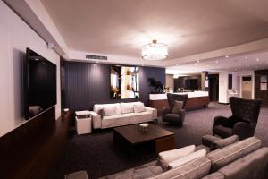 a living room with a couch and two chairs at UK ANKARA Hotel in Ankara