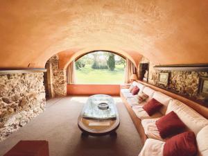 a living room with a couch and a window at Mas Salvi Country Boutique Hotel in Pals