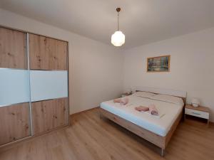 a bedroom with a bed and a glass shower at Apartment Marija in Novi Vinodolski