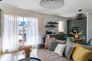 un salon avec un canapé et une cuisine dans l'établissement Cours Morny, à Deauville