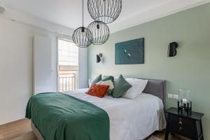 une chambre avec un grand lit avec deux lustres dans l'établissement Cours Morny, à Deauville