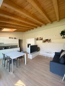 a living room with a table and a couch at Little Mier in Iseo