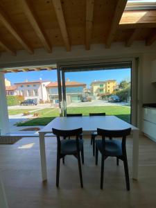 a table and chairs in a kitchen with a large window at Little Mier in Iseo +21 photos