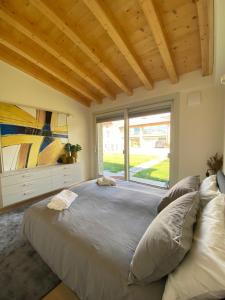 a bedroom with a large bed with a large window at Little Mier in Iseo