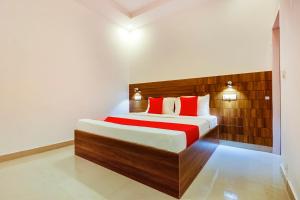 a bedroom with a large bed with red pillows at The Nest in Mohali
