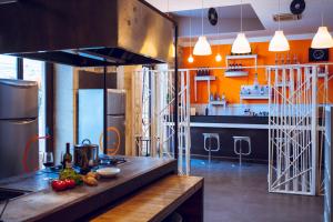 a kitchen with a counter with fruits and vegetables on it at LoL Hostel Siracusa in Siracusa