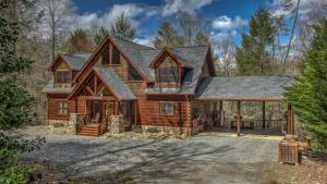 an image of a log home with a garage at Bearfoot Lodge in Epworth