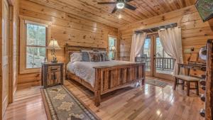 a bedroom with a bed in a log cabin at Bearfoot Lodge in Epworth