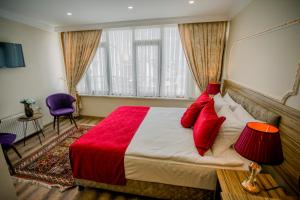 una camera da letto con un grande letto con cuscini rossi di Gülec Konak Hotel a Istanbul