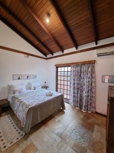 Cama ou camas em um quarto em Pousada Ikabana