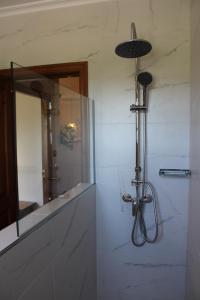 a bathroom with a large mirror and a shower at Apartamentos Los Hidalgos in Santillana del Mar +66 photos