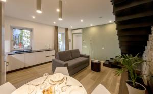 a living room with a couch and a table at Residence Casa Coppa Appartamento Duplex in Omegna