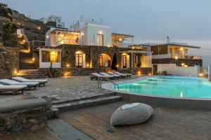 Villa con piscina frente a un edificio en ONE-VILLAS Cosset Villa BohoChic Sea&HarbourView and Sunset en Ornos