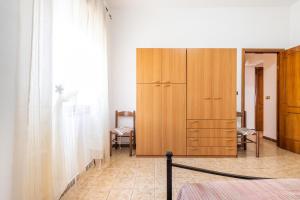 Posteľ alebo postele v izbe v ubytovaní Casa Vacanze Teulada