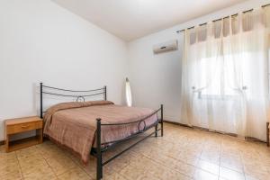 Posteľ alebo postele v izbe v ubytovaní Casa Vacanze Teulada