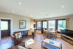 a living room with a couch and a table at Birch Lodge in Newton Stewart