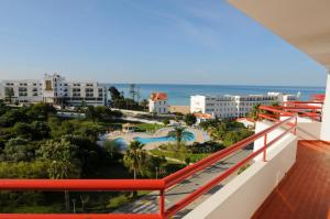 a balcony with a view of a resort and the ocean at INATEL Albufeira in Albufeira