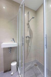 a bathroom with a shower and a toilet and a sink at Studio with a panoramic view at the last floor of the residence with a pool in Antibes +14 photos