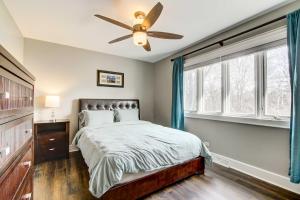 a bedroom with a bed and a ceiling fan at Classy Lakefront Home with Charcoal Grill and Deck! in Prospect Heights