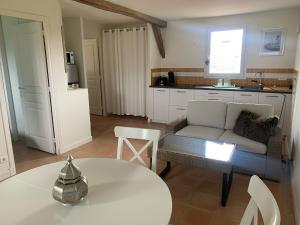 a living room with a couch and a table at Majellon Grand Appartement in Sainte-Christie-dʼArmagnac