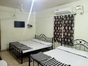 Postel nebo postele na pokoji v ubytování Stay Goa Guesthouse