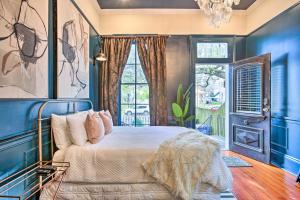 a blue bedroom with a bed and a window at Walk to Magazine Street Contemporary NOLA Studio in New Orleans