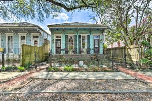 a house with a fence in front of it at Walk to Magazine Street Contemporary NOLA Studio in New Orleans