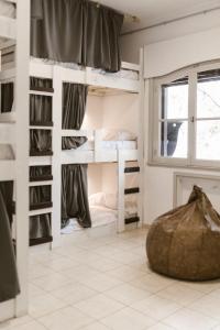 a room with bunk beds and a window at El Nido Hostel in San Rafael