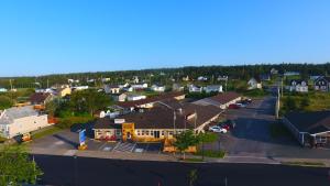 an aerial view of a small town with a parking lot at Fortress Inn Louisbourg in Louisbourg