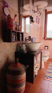 a bathroom with a sink and a bowl on a counter at Casa Ferrini in Marciana