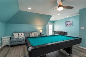 a living room with a pool table and a couch at Strand Castle - GULF FRONT! An ideal layout with game room, small private pool, and roof top crow's nest! home in Dauphin Island