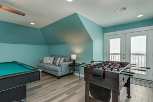 a living room with a pool table and a couch at Strand Castle - GULF FRONT! An ideal layout with game room, small private pool, and roof top crow's nest! home in Dauphin Island