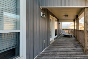 a porch of a house with a bench on it at Strand Castle - GULF FRONT! An ideal layout with game room, small private pool, and roof top crow's nest! home in Dauphin Island